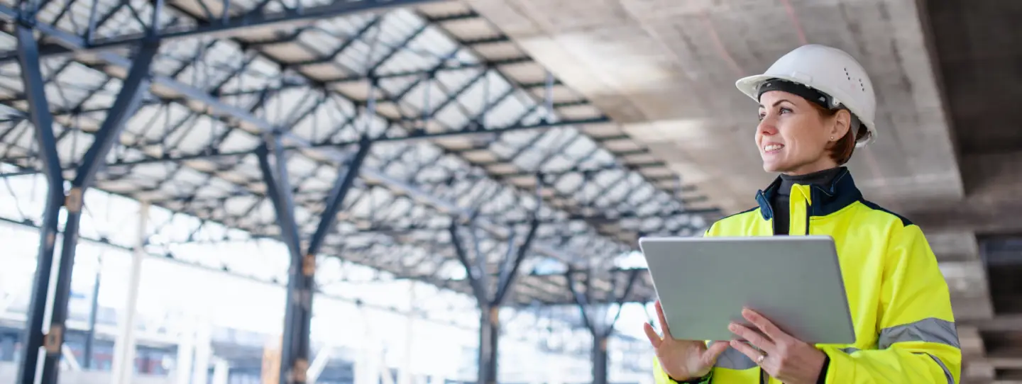 construction worker wearing high vis holding tablet