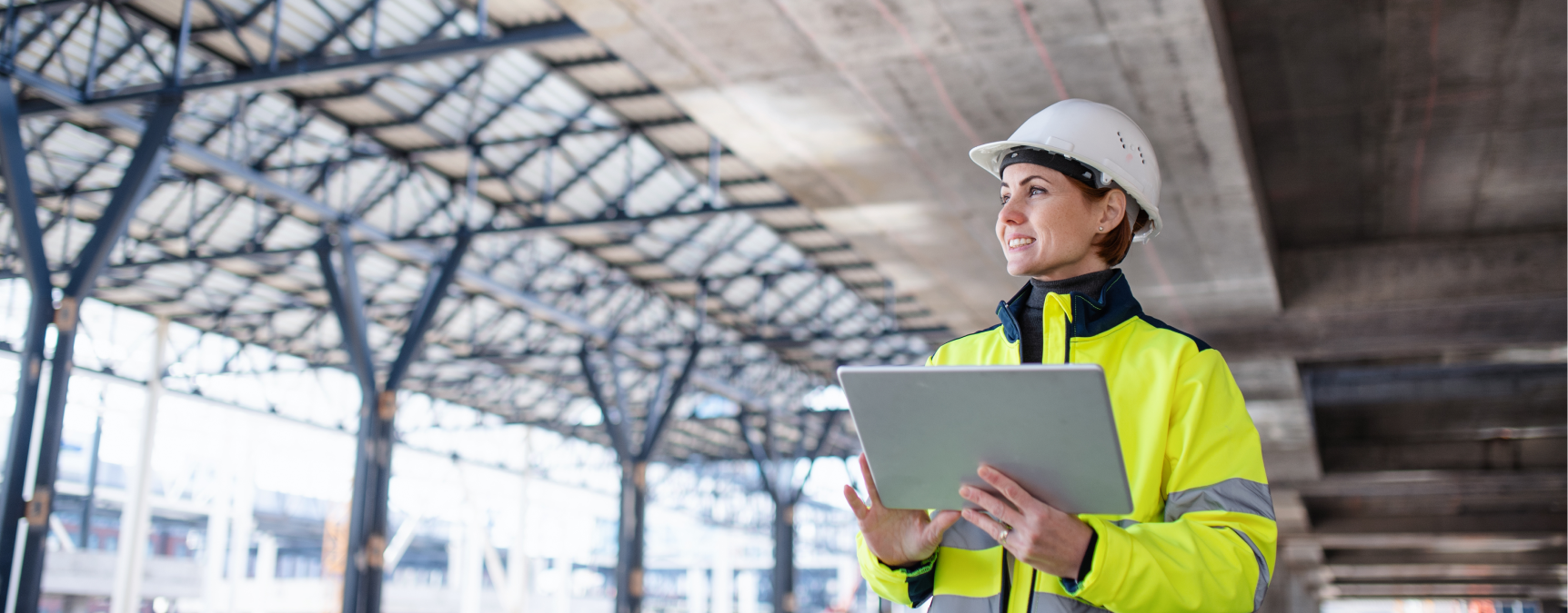 Construction worker holding a tablet wearing high-vis